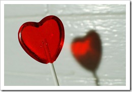 red heart-shaped cinnamon-cherry lollipop photographed from the back