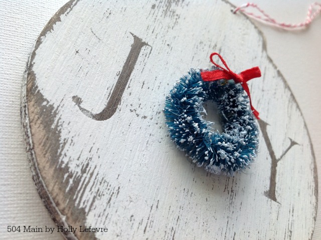 Wood Joy ornaments accented with a wreath
