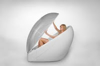 woman emerging from an egg-like structure