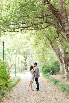 couple kissing under trees