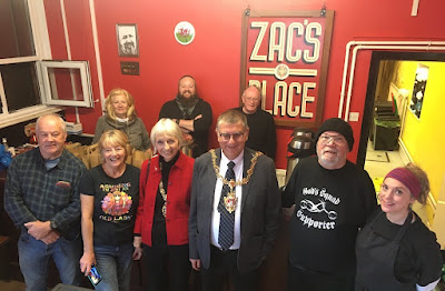 A group of Zac's Place staff and volunteers are picture with the Mayor and Mayoress of Swansea inside the venue.