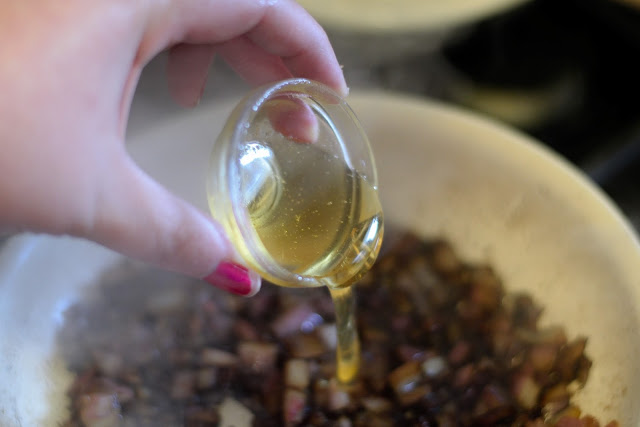 Honey being added to the onions. 