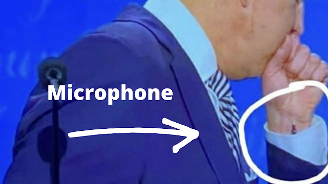 Biden wearing microphone cheating on live TV.