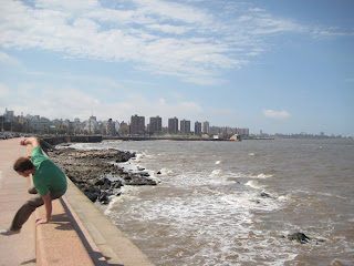 Johnny leaping over the sea wall along the seafront of Montevideo.