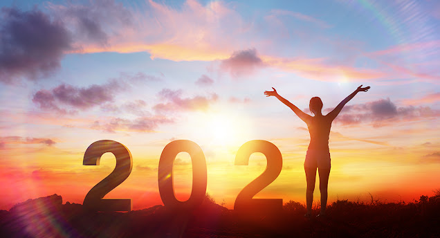 In what feels like an image from an alternate reality, a beautiful golden sunrise forms the backdrop for block numbers “202.” In place of the “1,” the silhouette of a young woman stands with her arms up as if in joyous greeting to the new year