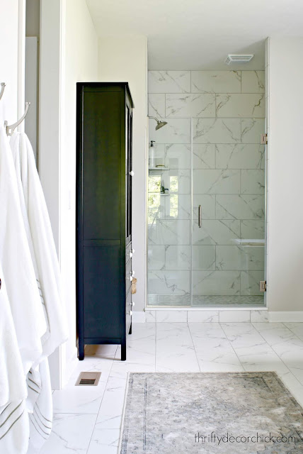 Black tall cabinet in bathroom for storage 