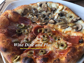 The ½ truffle shuffle and ½ slyce special pizza with mushrooms, truffle oil, pepperoni, olives and more at Slyce Pizza Bar on Indian Rocks Beach, Florida.
