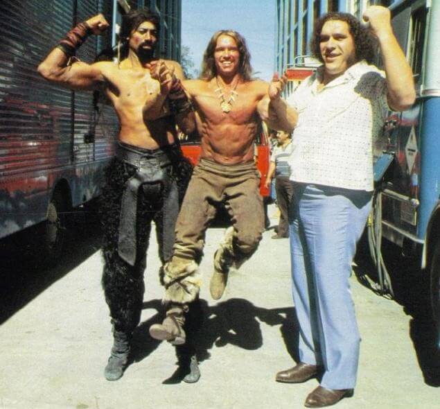 60 Iconic Behind-The-Scenes Pictures Of Actors That Underline The Difference Between Movies And Reality - The Big 3 Wilt Chamberlain, Arnold Schwarzenegger, and Andre the Giant, seen goofing around on the set of