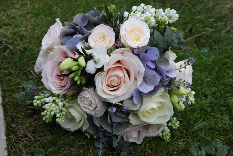 A gorgeous Vintage Pink Blue wedding bouquet in lovely spring blooms 