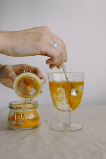 adding turmeric in a glass of water