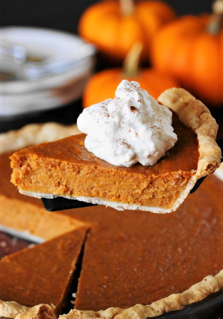 Serving a Piece of Sweet Potato Pumpkin Pie with Whipped Cream Image