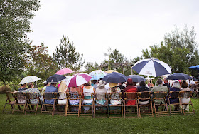 Guests sitting in the rain, waiting on the bride to walk down the aisle