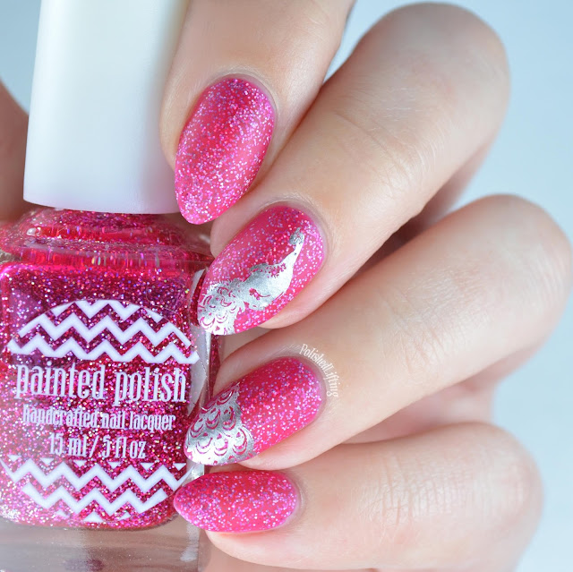 Matte pink nail polish with peacock stamping