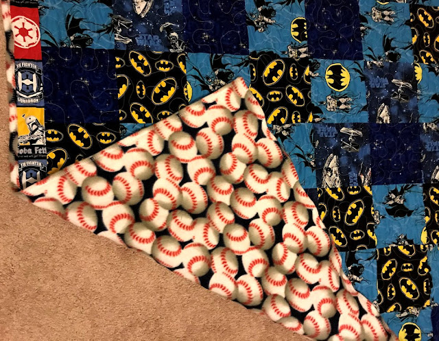 quilt with starwars, batman and baseballs