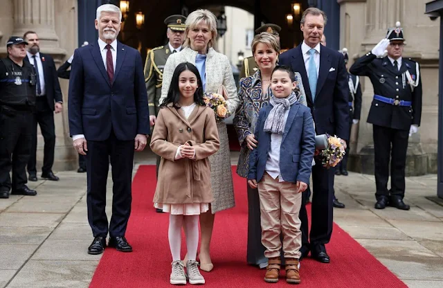 President Petr Pavel and First Lady Eva Pavlova. Duchess Maria Teresa wore a velvet stitch jacquard pea coat by Etro