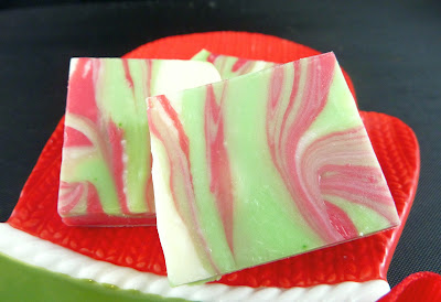 Pieces of red, green, and white swirled fudge, photographed on a red mitten-shaped plate