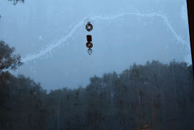 a trail across the window's condensation