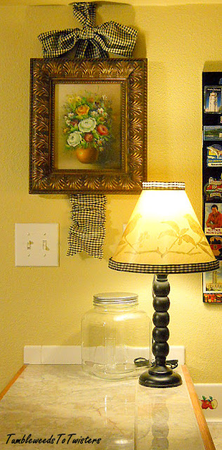 floral oil painting with checkered ribbon bow and peek-a-boo lamp with checkered trim