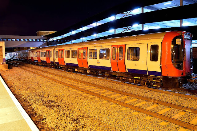 Night Photo of new London Underground rolling stock pause at Banbury station on an April night in 2017 while being hauled by four Class 20 diesel locomotives.