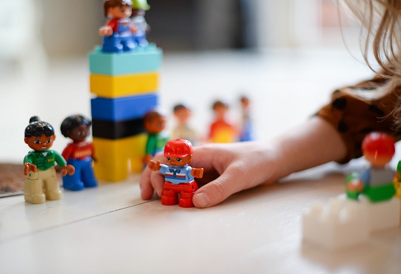 girl playing with duplo people