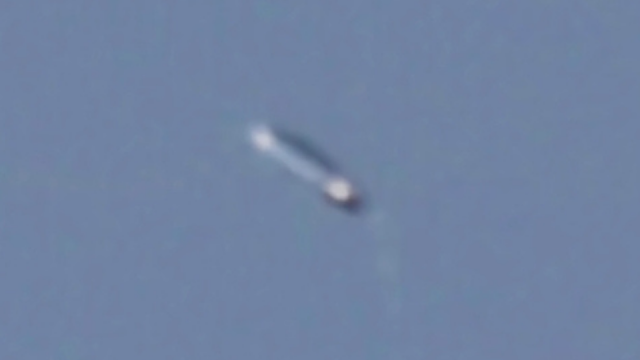 White Cigar looking tube UFO in the sky photographed by witness.