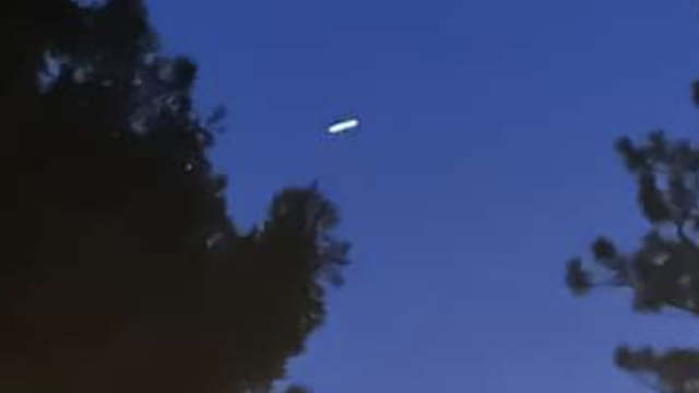 Eye witness has filmed a white Disk UFO right next to his home in Grass Valley CA USA.