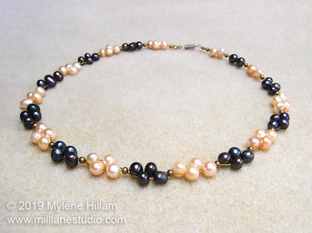 Pearl necklace strung with navy and peach coloured freshwater pearls