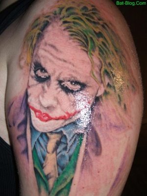 Joker face tattoo on left arm