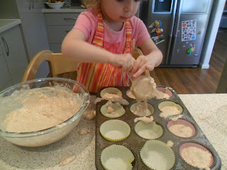 Using a 1/4 cup measure to fill tray for muffin recipe