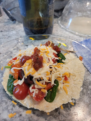 Tortilla with chicken, spinach, sliced baby tomatoes, diced red peppers, sliced olives, shredded cheese, plain yogurt and salsa.