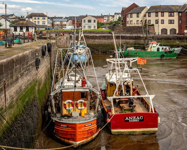 Photo of two more fishing boats sitting on the mud