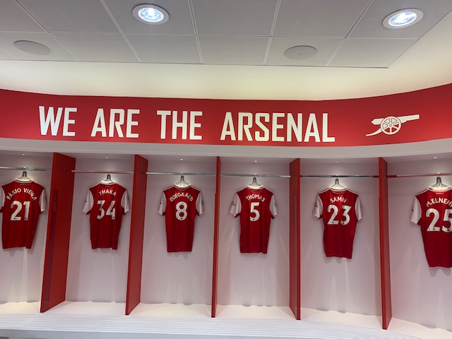 Changing rooms with Arsenal player shirts hanging up
