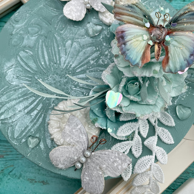 Aqua Dreams mixed media canvas created with: Sizzix agave creamy matte acrylic paint, pearlescent medium, dimensional paste, sequins mint julep, woodland stems die, muted cardstock surfacez; Rneabouqeuts butterflies, lace, glitter glass