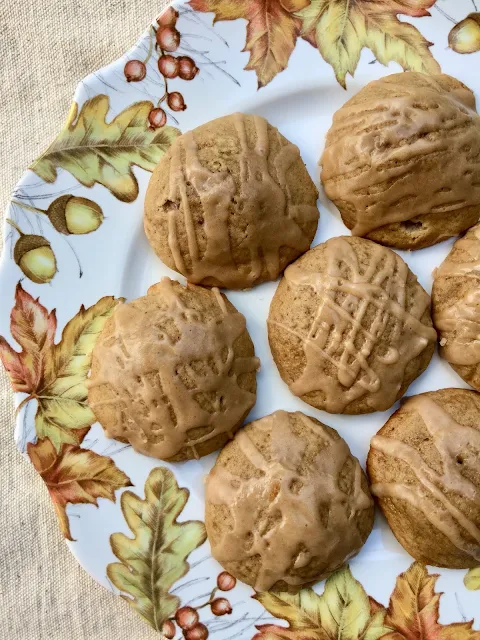Plate of finished glazed spiced apple cider cookies.