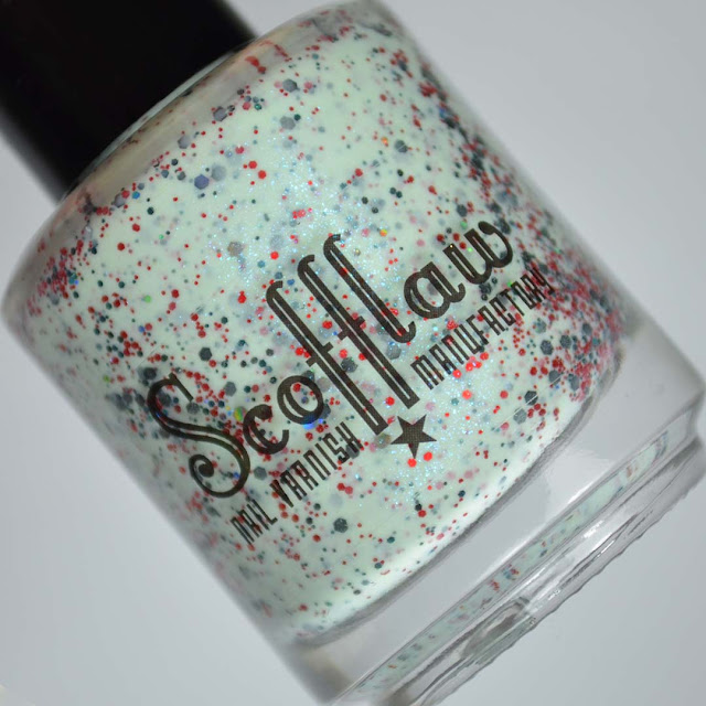 mint nail polish with red and black glitter in a bottle