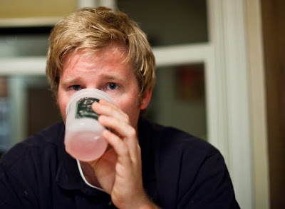 a man drinks from a cup