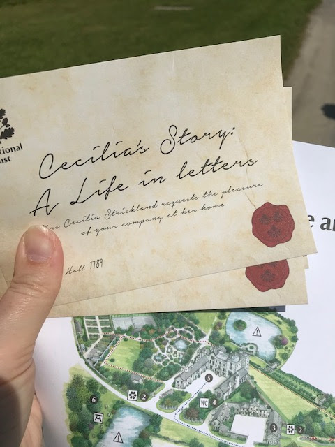 Old style invitations with a faux wax seal and a map of the grounds