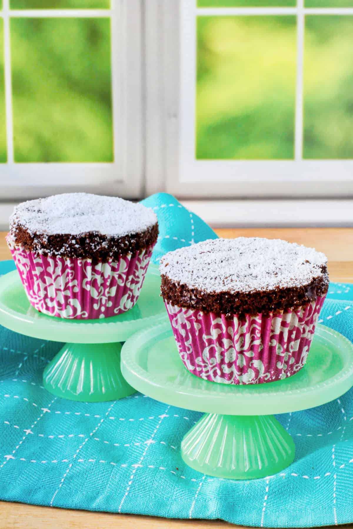 Chocolate Almond Muffins on pale green mini cake stands.