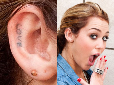 miley cyrus cross tattoo finger. The second tattoo that Miley