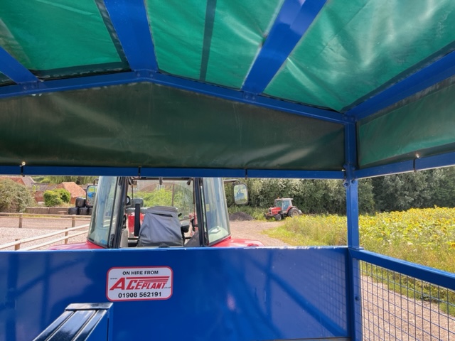 a blue and green canopy on a tractor
