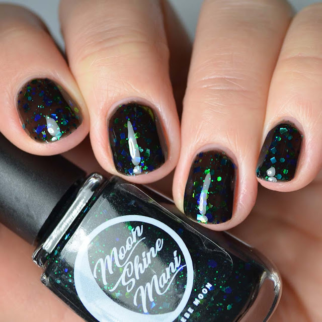 black jelly nail polish with black and green glitter swatch