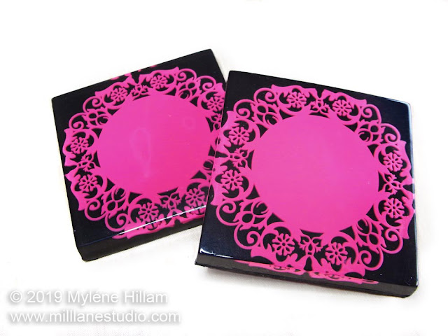 Black square coaster embedded with magenta doiley