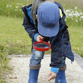 child with magnifying glass