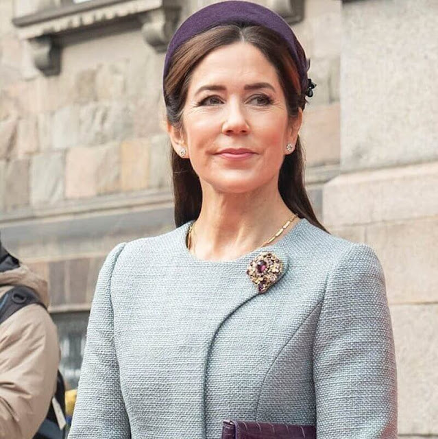 Crown Princess Mary wore a pale blue coat by Claes Iversen. Gianvito Rossi pumps. Jane Taylor purple hat