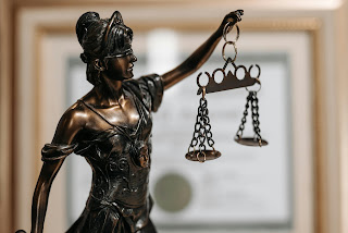 Themis the Goddess of Justice blindfolded holding a set of scales.  Image credit Pavel Danilyuk at Pexels.com