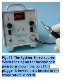 Fig. 11  The System-B heat source. When the ring on the handpiece is pressed as shown the tip of the plugger is immediately heated to the temperature selected.