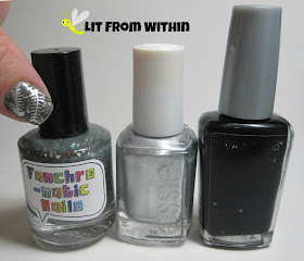 Bottle shot: Fanchromatic Nails To The Edge Of Night,  Essie No Place Like Chrome, and Wet 'n Wild Black Creme.