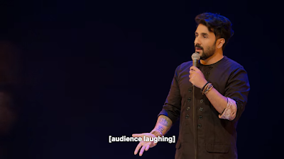 Vir Das with subtitles saying “Audience laughing.”