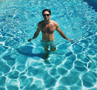 Carlo Marks posing for a picture in swimming pool