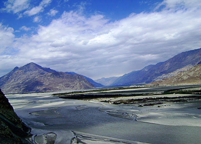 colourful scene of mountains and frozen rivers